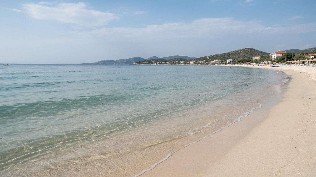 Calm shallow water over pale sand at a family beach on the Turkish coast